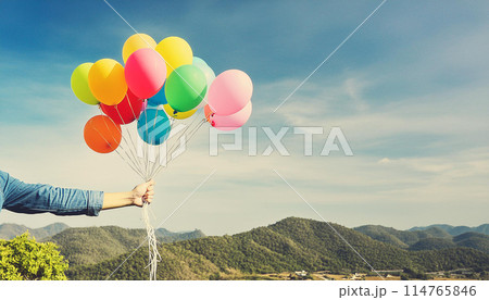 hand catch many baloons flying sky scream on the colored background. 114765846