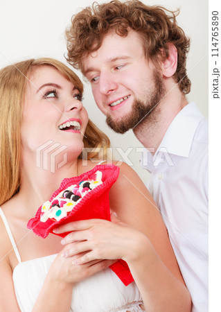 Loving couple with candy bunch flowers. Love. 114765890
