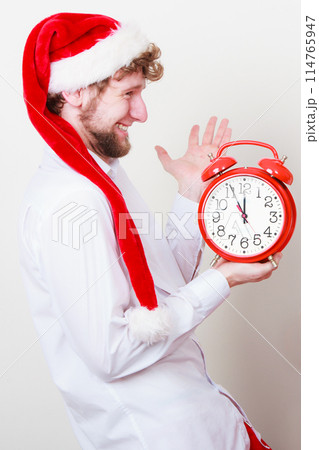 Happy man with alarm clock. Christmas time. 114765947