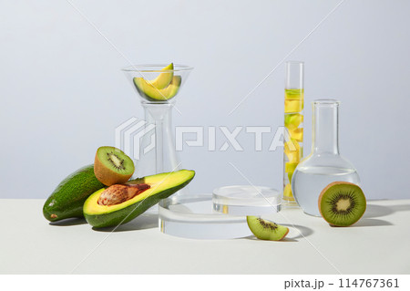Concept laboratory tests and research with kiwis and avocados arranged with some glassware. Collection of podiums and pedestals for product presentation Concept laboratory tests and research with kiwis and avocados arranged with some glassware. Collection of podiums and pedestals for product presentation 114767361