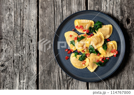italian pasta mezzelune on a plate, top view italian pasta mezzelune on a plate, top view 114767800