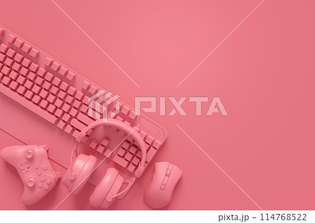 Modern home office setup featuring keyboard, gaming controllers and headphones 114768522