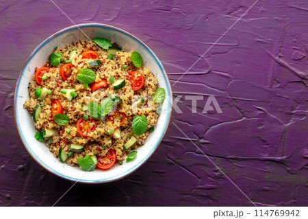 Quinoa tabbouleh salad in a bowl, a healthy dinner with tomatoes and mint Quinoa tabbouleh salad in a bowl, a healthy dinner with tomatoes and mint 114769942