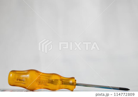 A yellow screwdriver with a silver tip 114772809
