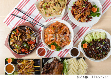 Assorted Asian dishes on wooden table Assorted Asian dishes on wooden table 114773752