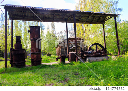 Old steaming threshing machine in Open air Museum of Folk Architecture and Folkways of Middle Naddnipryanschina in Pereyaslav, Ukraine 114774282