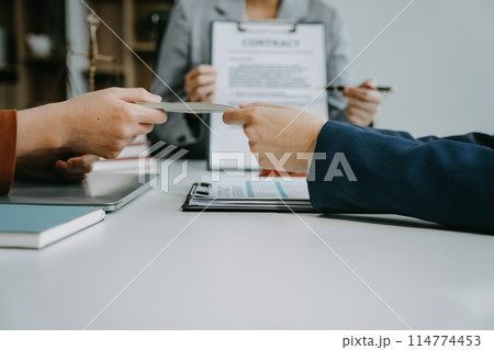 Teamwork of business lawyer meeting working hard about legal legislation in courtroom to help their customer. Teamwork of business lawyer meeting working hard about legal legislation in courtroom to help their customer. 114774453