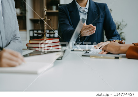 Teamwork of business lawyer meeting working hard about legal legislation in courtroom to help their customer. 114774457