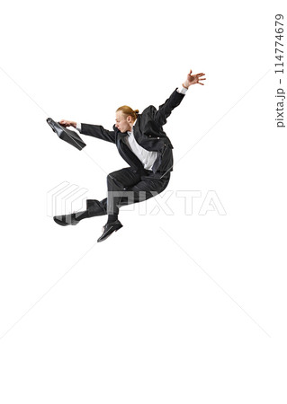 Business professional in suit performing dynamic leap. Swift and decisive movements required for success in corporate world. Business professional in suit performing dynamic leap. Swift and decisive movements required for success in corporate world. 114774679