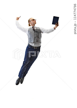 Young man dressed smart casual outfit and gracefully jumps and using tablet against white studio background. Young man dressed smart casual outfit and gracefully jumps and using tablet against white studio background. 114774786