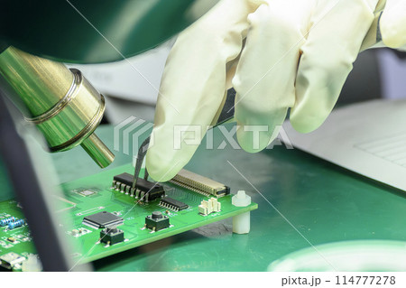 Close up scene the PCB board assembly process by operator. Close up scene the PCB board assembly process by operator. 114777278
