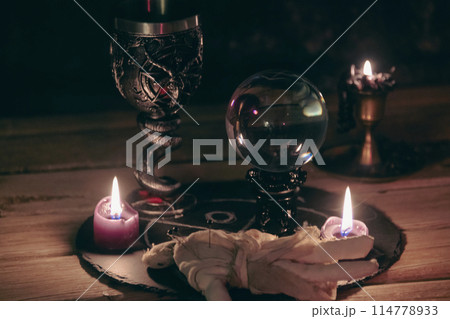 Mysterious Occult Ritual Setup with Crystal Ball and Candles. Mysterious Occult Ritual Setup with Crystal Ball and Candles. 114778933