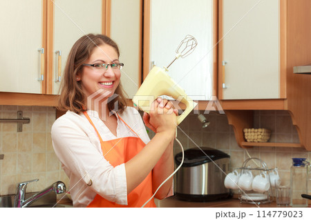 Funny housewife with mixer 114779023