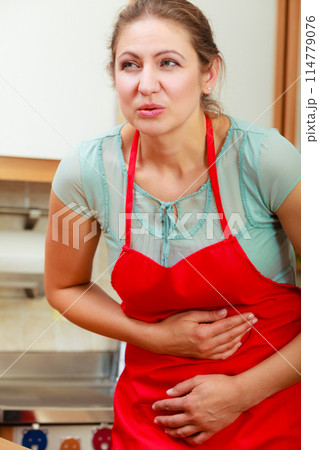 Woman suffering from stomach ache abdominal pain. 114779076