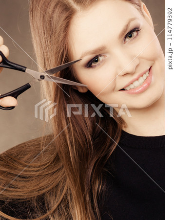 Professional hairdresser with scissors ready to cut. Professional hairdresser with scissors ready to cut. 114779392