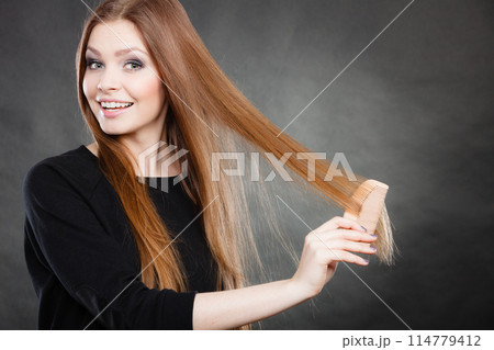 Long haired girl combing her beauty hair. Long haired girl combing her beauty hair. 114779412
