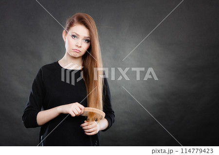 Long haired girl combing her beauty hair. Long haired girl combing her beauty hair. 114779423