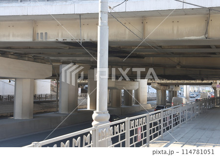 Overpasses on the background of skyscrapers. Blue sky and bright sun. Overpasses on the background of skyscrapers. Blue sky and bright sun. 114781051