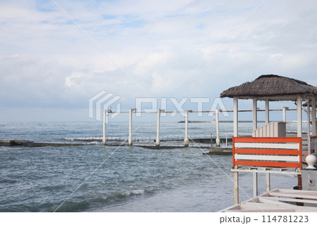Sochi, Russia 05.07.2021. Breakwater pier summer black sea cloudy. Sochi, Russia 05.07.2021. Breakwater pier summer black sea cloudy. 114781223