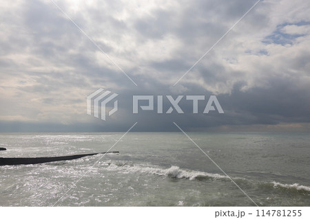 Sochi, Russia 05.07.2021. Breakwater pier summer black sea cloudy. Sochi, Russia 05.07.2021. Breakwater pier summer black sea cloudy. 114781255