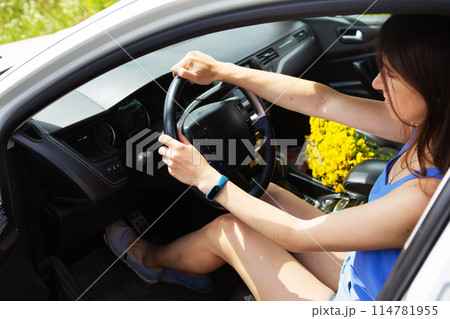 Young girl driving a car, handing over the right to drive a car. 114781955