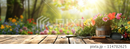 Colorful flowers and gardening tools neatly arranged on a wooden table with a blurred nature backdrop. Generative AI 114782625