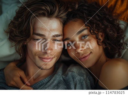 Portrait of smiling couple with freckles sharing a close, loving moment 114783025