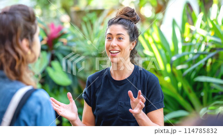 Female coach leads a garden workshop on sustainable living. Female coach leads a garden workshop on sustainable living. 114785832