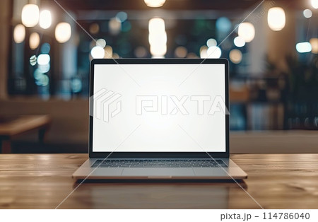 A laptop and a cup of coffee on a table in an interior with wooden flooring 114786040