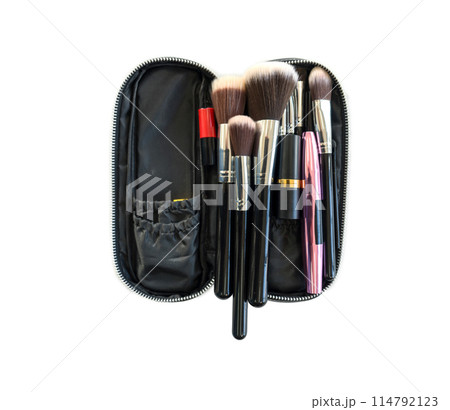 A set of various makeup brushes is neatly arranged in an open black zippered case. Studio shot on white background. Isolated A set of various makeup brushes is neatly arranged in an open black zippered case. Studio shot on white background. Isolated 114792123