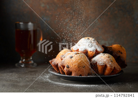 Homemade raisin cupcakes sprinkled with powdered sugar. Homemade raisin cupcakes sprinkled with powdered sugar. 114792841