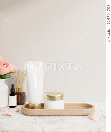 A lotion tube and a facial cream jar mockup are on a white marble tabletop against the white wall. 114794708