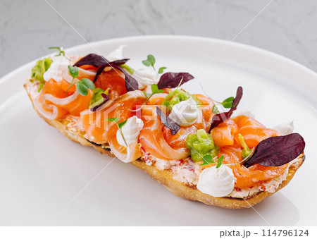 Gourmet smoked salmon bruschetta on white plate Gourmet smoked salmon bruschetta on white plate 114796124