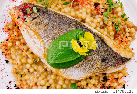 Grilled salmon fillet with herb couscous on plate Grilled salmon fillet with herb couscous on plate 114796129