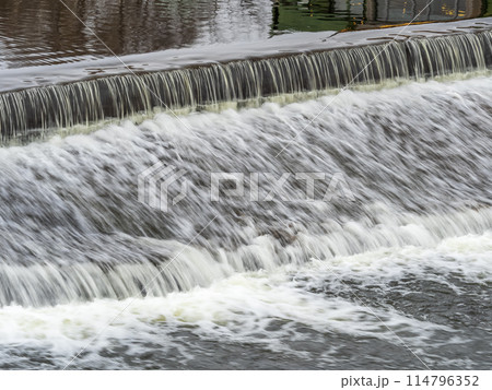 A small flat cascade in a calm river A small flat cascade in a calm river 114796352