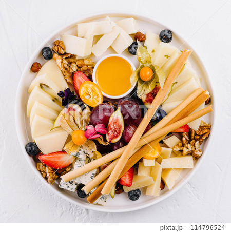 Gourmet cheese platter with fruits and nuts Gourmet cheese platter with fruits and nuts 114796524