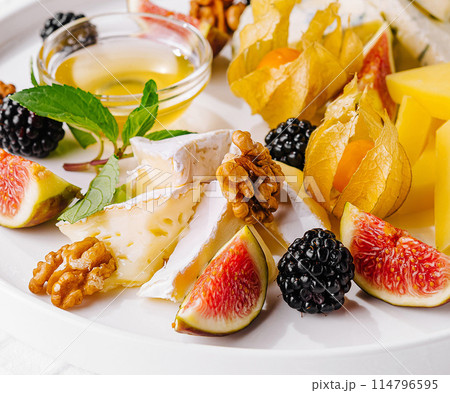 Gourmet cheese platter with fresh fruits and nuts Gourmet cheese platter with fresh fruits and nuts 114796595