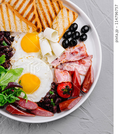 Full breakfast plate with eggs, bacon, and toast 114796757