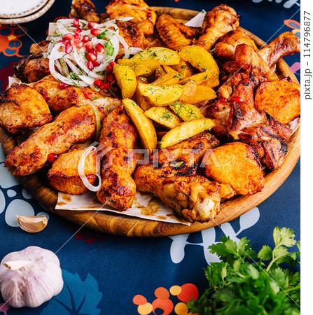 Traditional spicy roasted chicken and potatoes feast Traditional spicy roasted chicken and potatoes feast 114796877