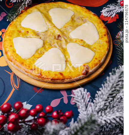 Festive cheese pizza under christmas tree 114796878
