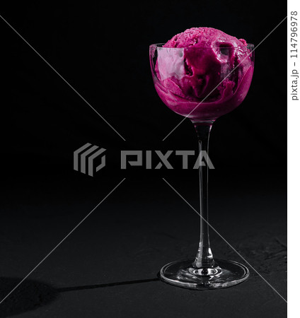 Elegant glass of raspberry sorbet on black background Elegant glass of raspberry sorbet on black background 114796978