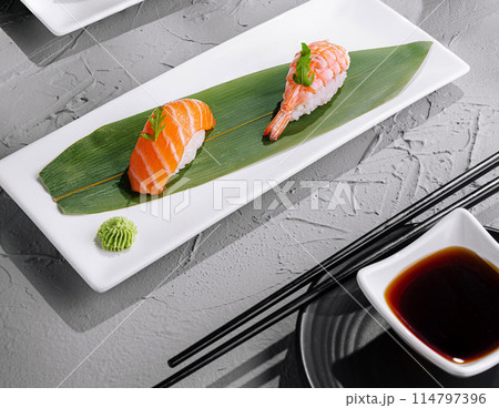 Delectable sushi platter on elegant table setting Delectable sushi platter on elegant table setting 114797396