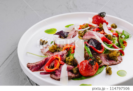 Gourmet beef carpaccio salad on white plate 114797506