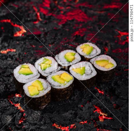 Avocado sushi rolls on molten lava texture Avocado sushi rolls on molten lava texture 114798471