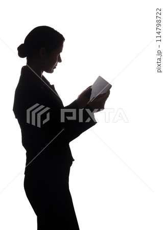 Young woman in suit shows pointer forward, side view - silhouette 114798722