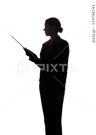 Young woman in suit shows pointer forward, side view - silhouette Young woman in suit shows pointer forward, side view - silhouette 114798741