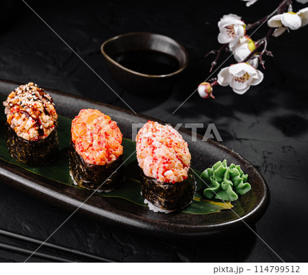 Gourmet sushi selection on elegant dark table Gourmet sushi selection on elegant dark table 114799512