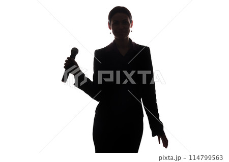 Young woman singing into the microphone Young woman singing into the microphone 114799563