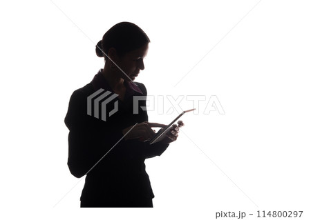 Young woman in suit shows pointer forward, side view - silhouette 114800297