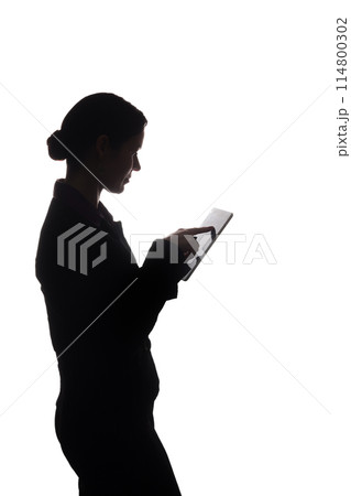 Young woman in suit shows pointer forward, side view - silhouette Young woman in suit shows pointer forward, side view - silhouette 114800302